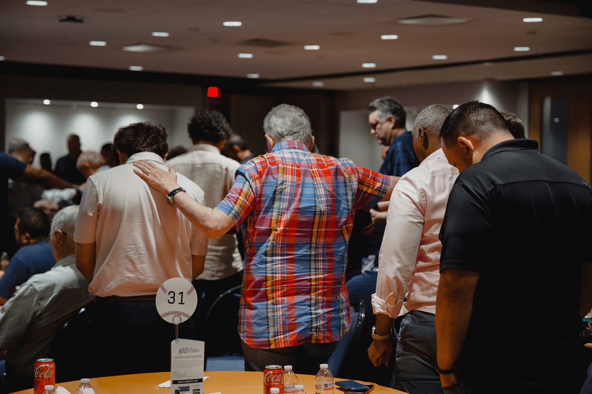 Men standing in prayer